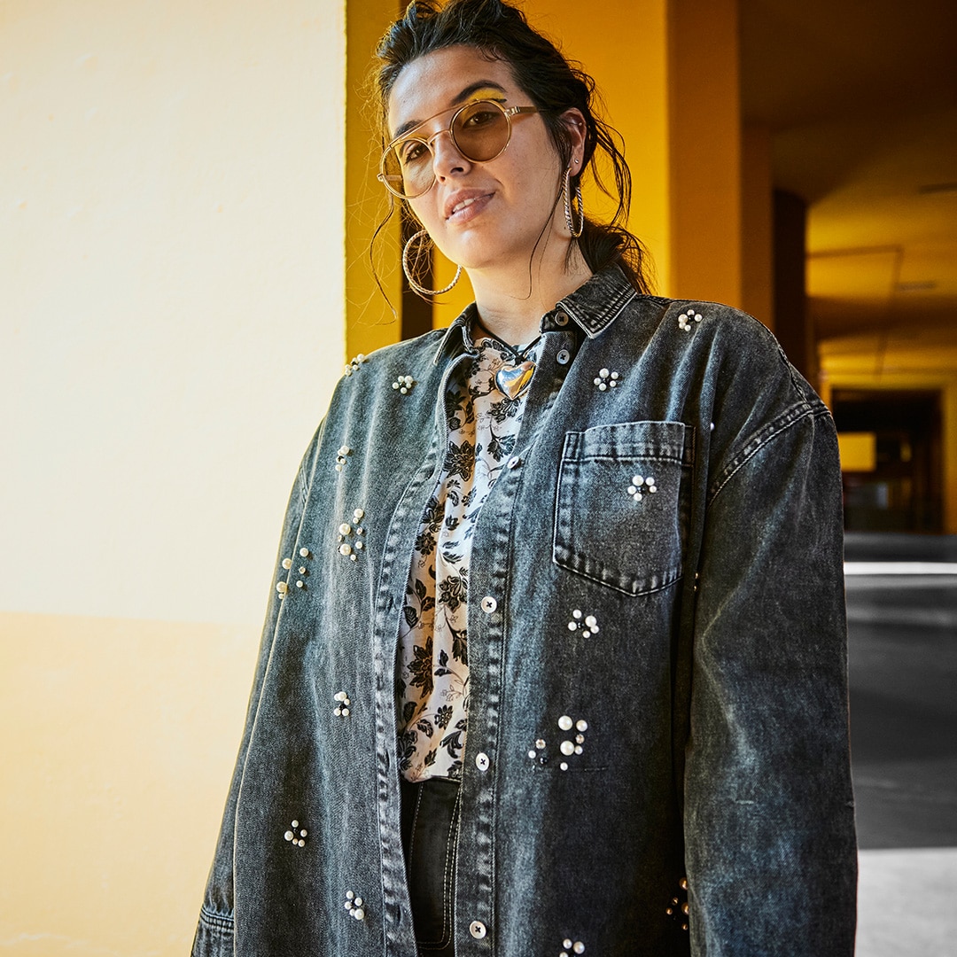 Woman wears oversize shirt with striped design