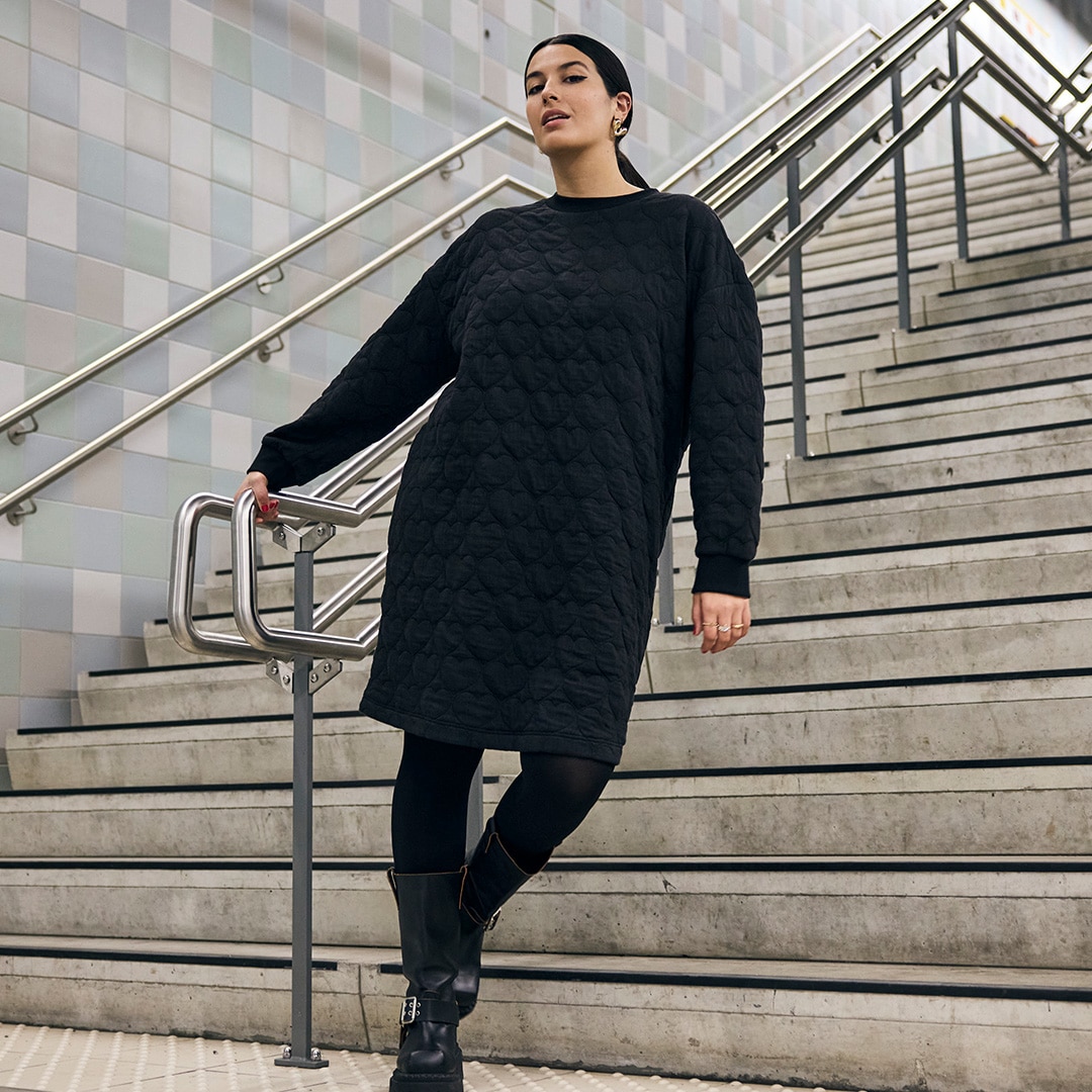 Woman wears oversize shirt with striped design