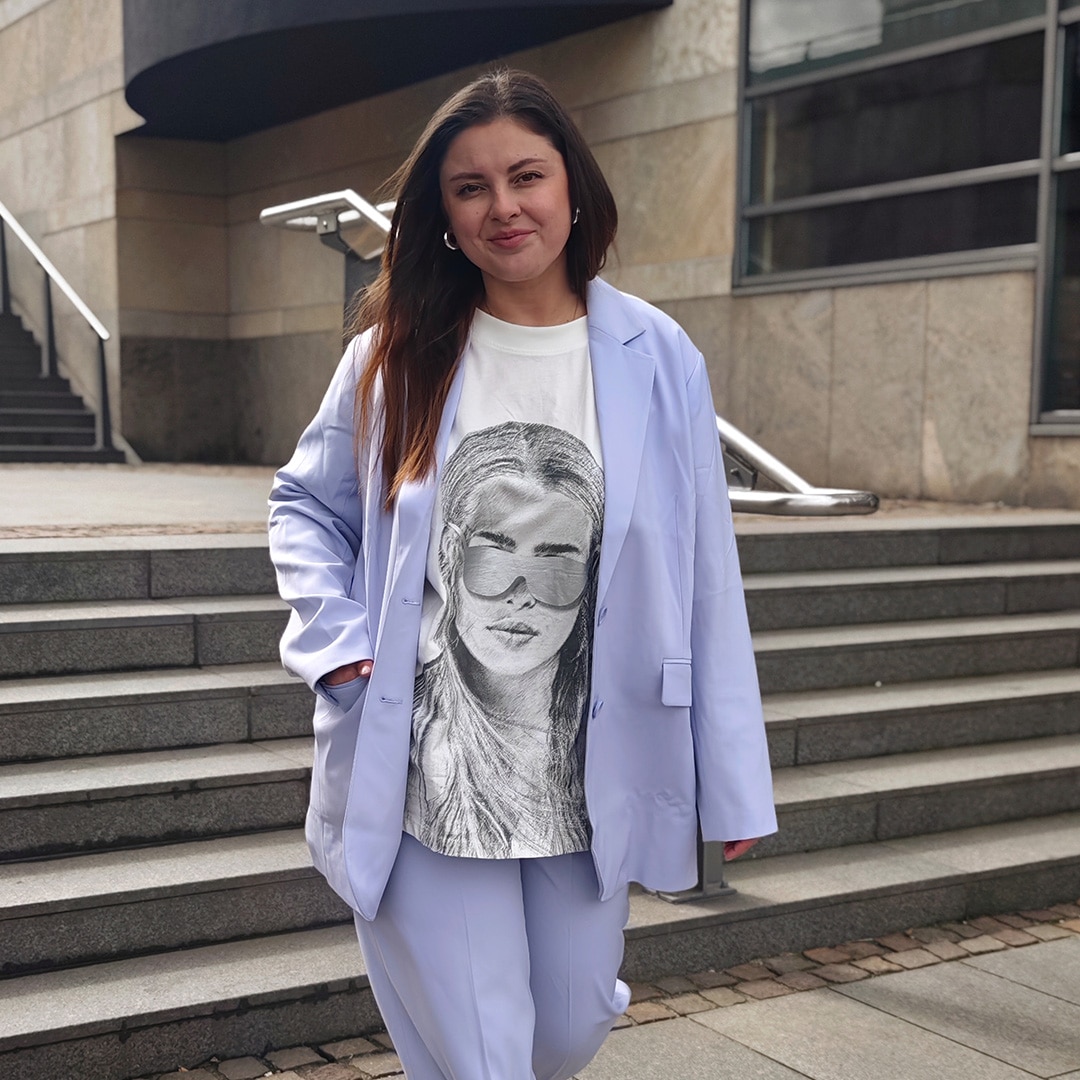 Model is wearing a green white purple pullover 