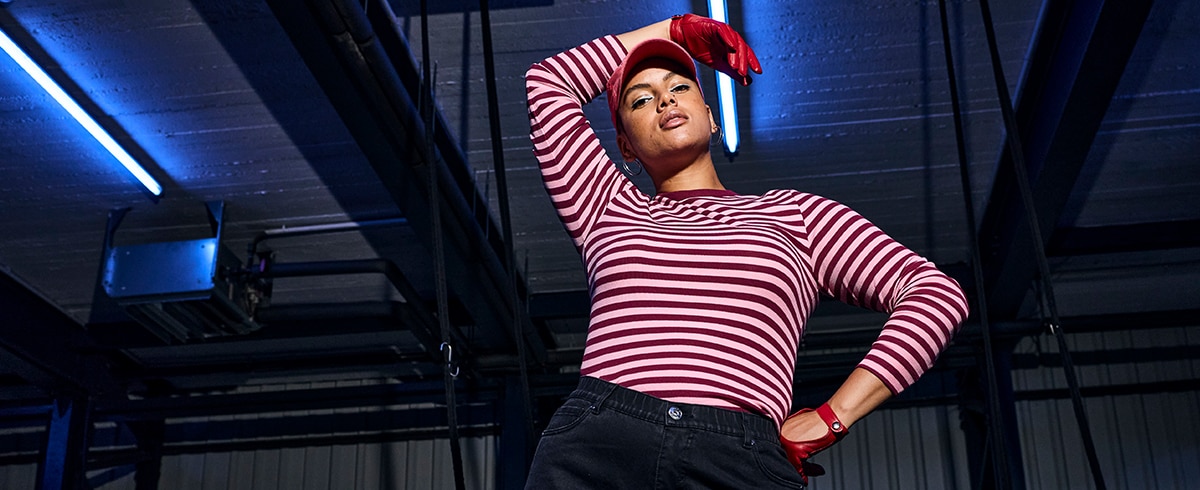 The model is wearing a red/pink striped shirt.