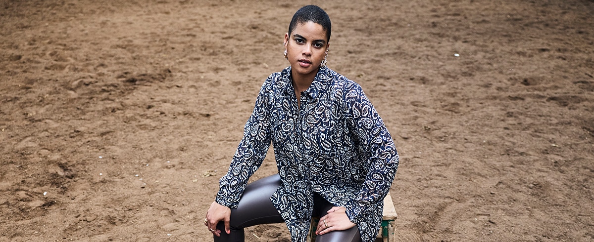 The model is wearing a blouse
