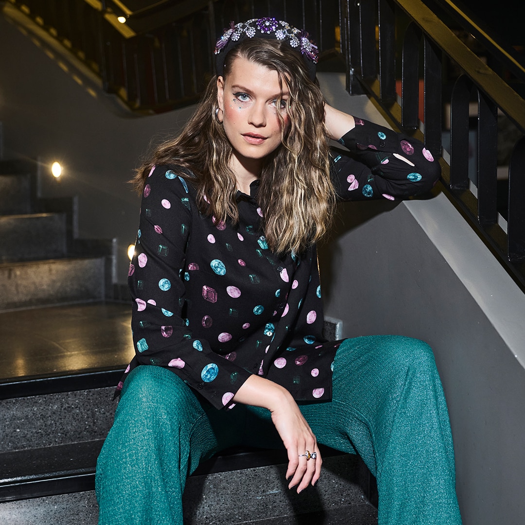 Woman wears oversize shirt with striped design