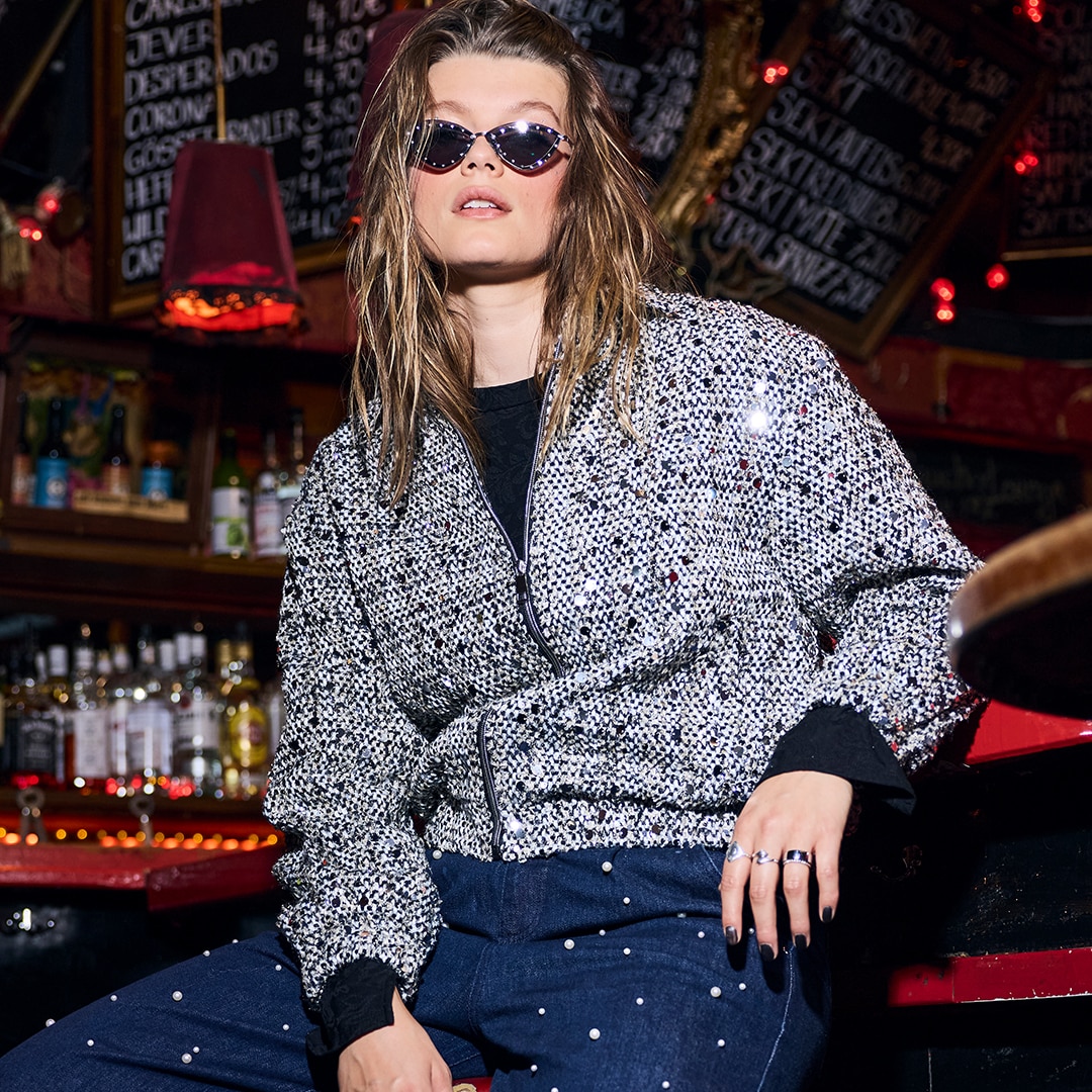 Woman wears chalk-coloured shirt blouse