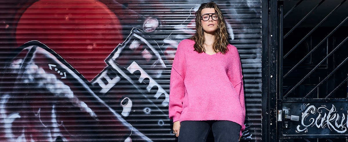 The model is wearing a blouse