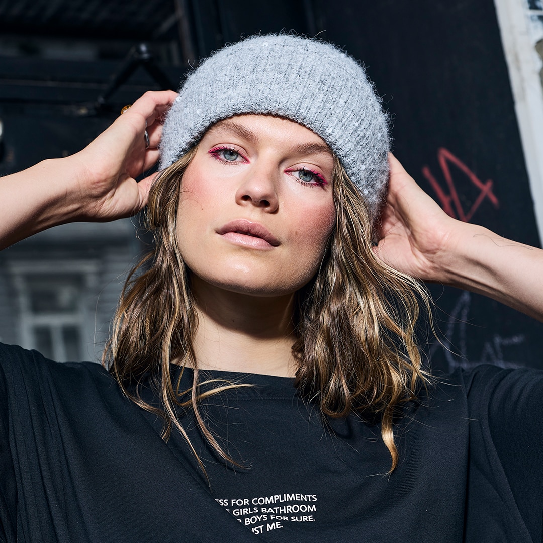 Model is wearing a green white purple pullover 