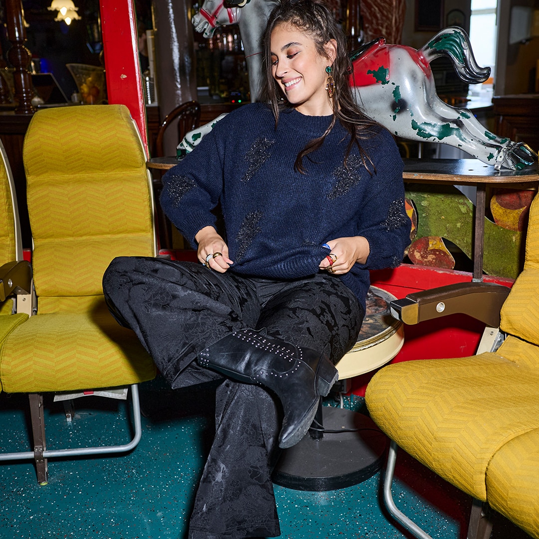 Woman wears oversize shirt with striped design