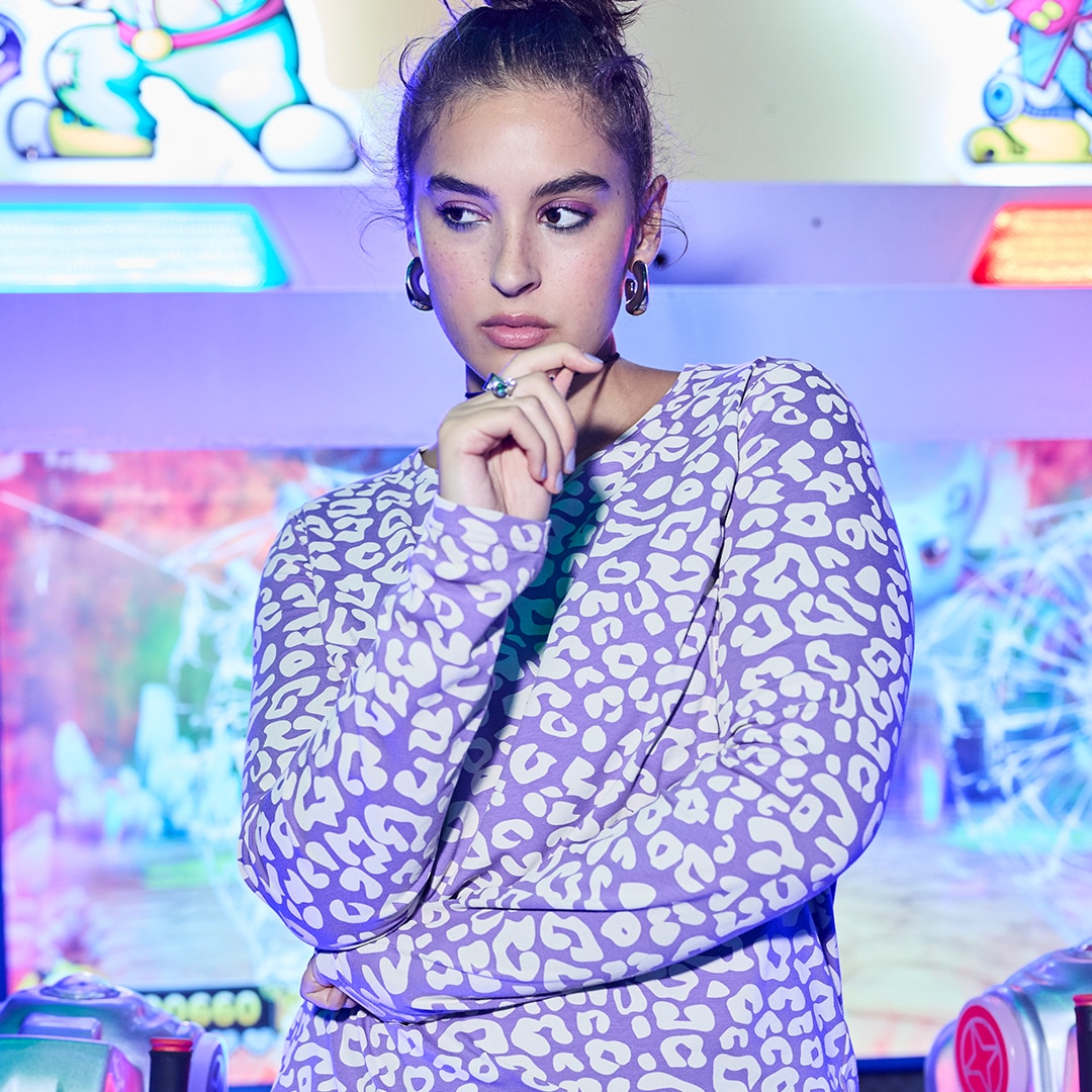 Woman wears chalk-coloured shirt blouse