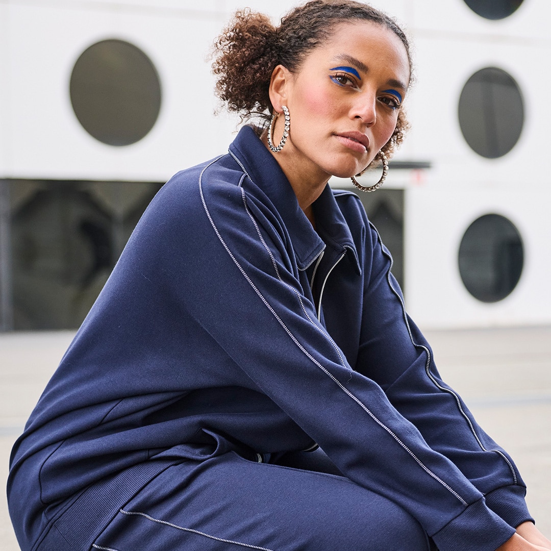 The model is wearing a green blouse.