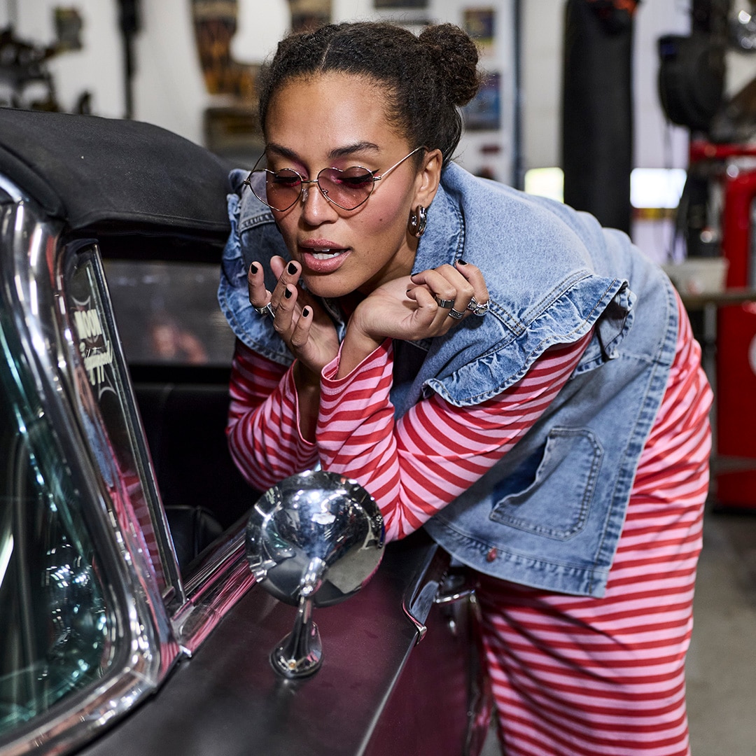 The model is wearing a black and white checked short jacket.