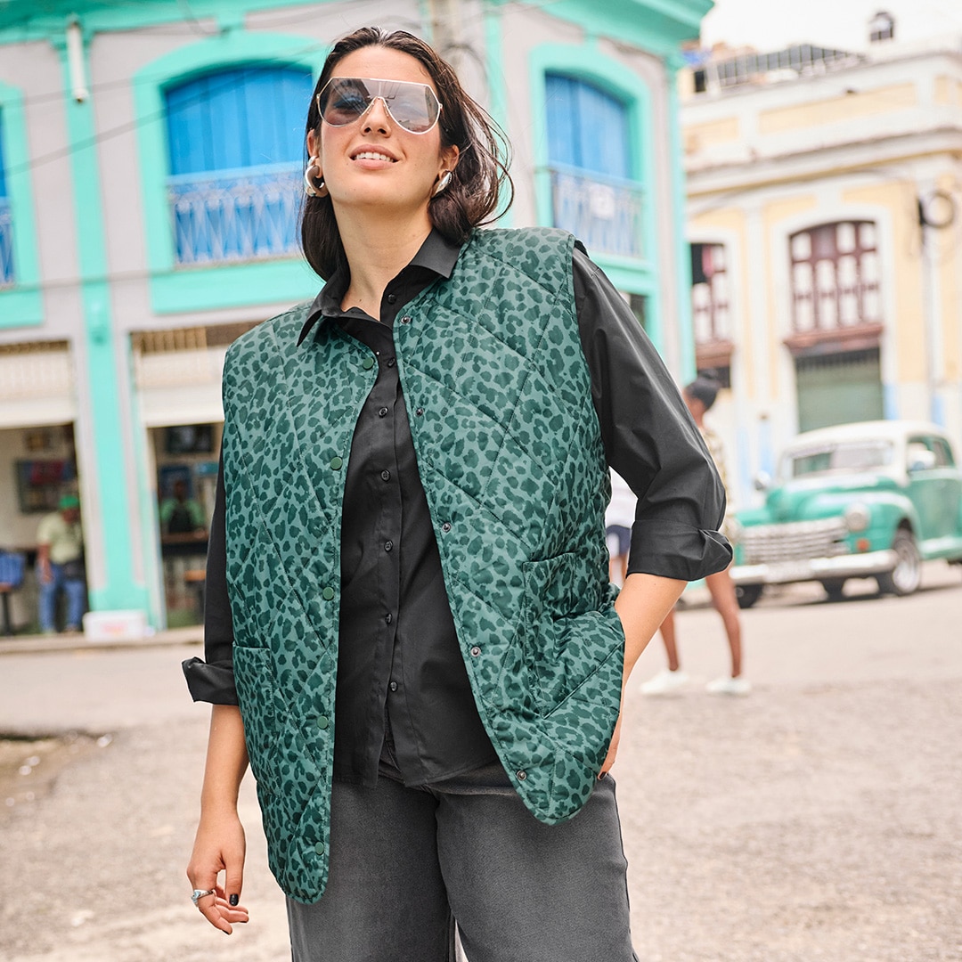 The model is wearing a black and white checked short jacket.