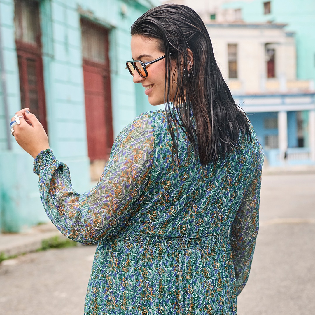 The model is wearing a black sweatshirt dress with very attractive black and white cowboy boots.