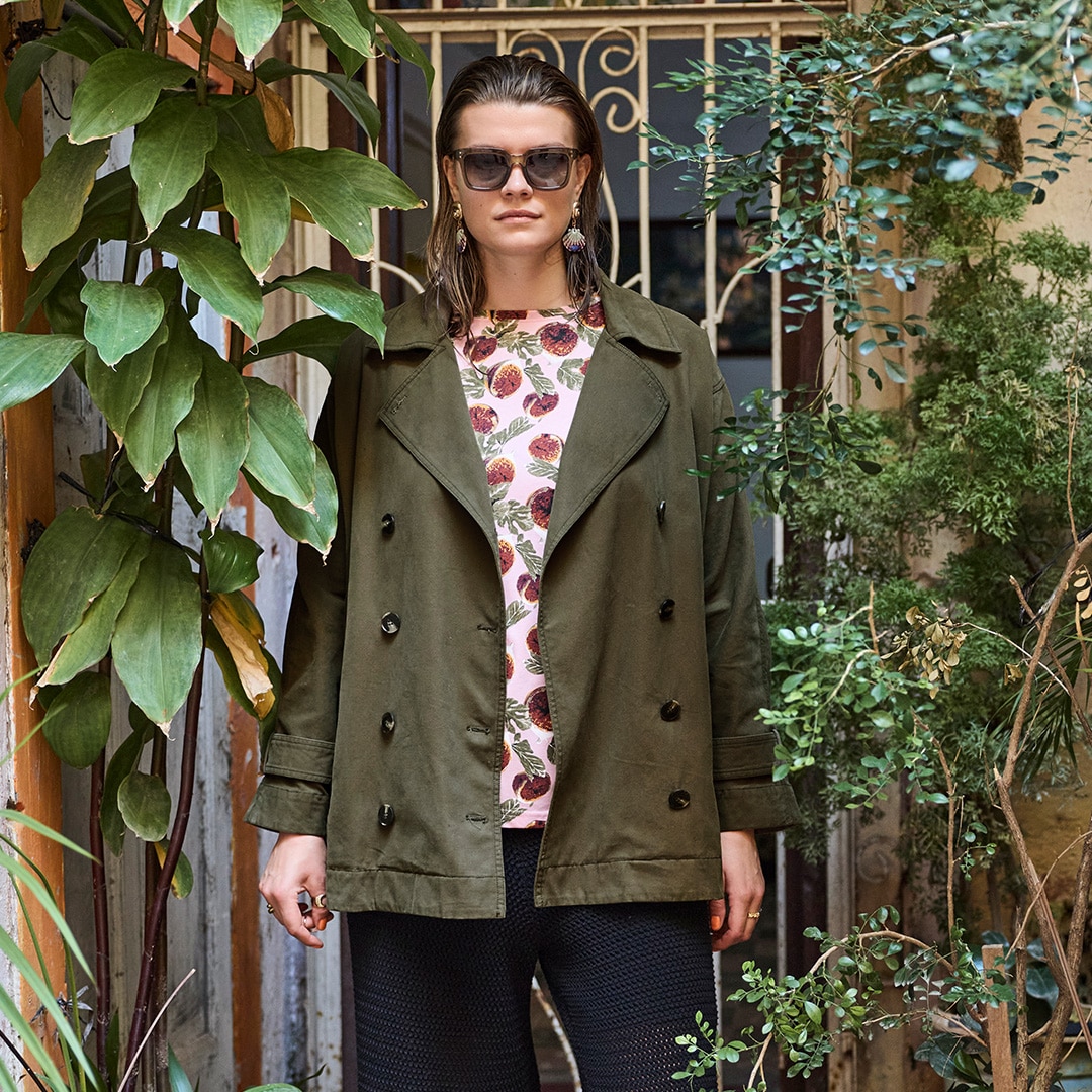 The model is wearing a green jacket