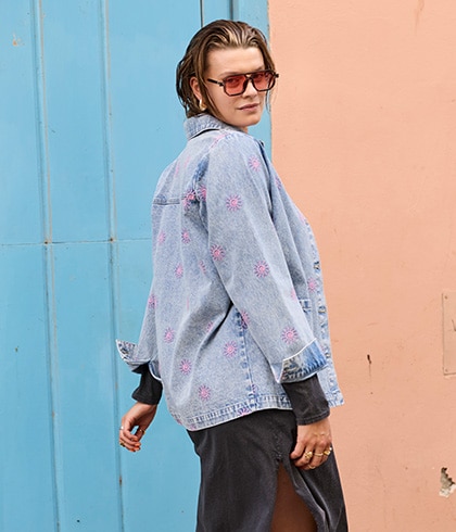 The model is wearing a denim jacket