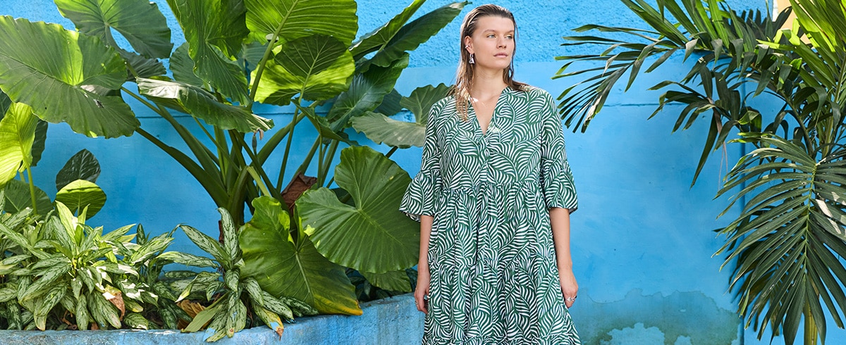 The model is wearing a green dress