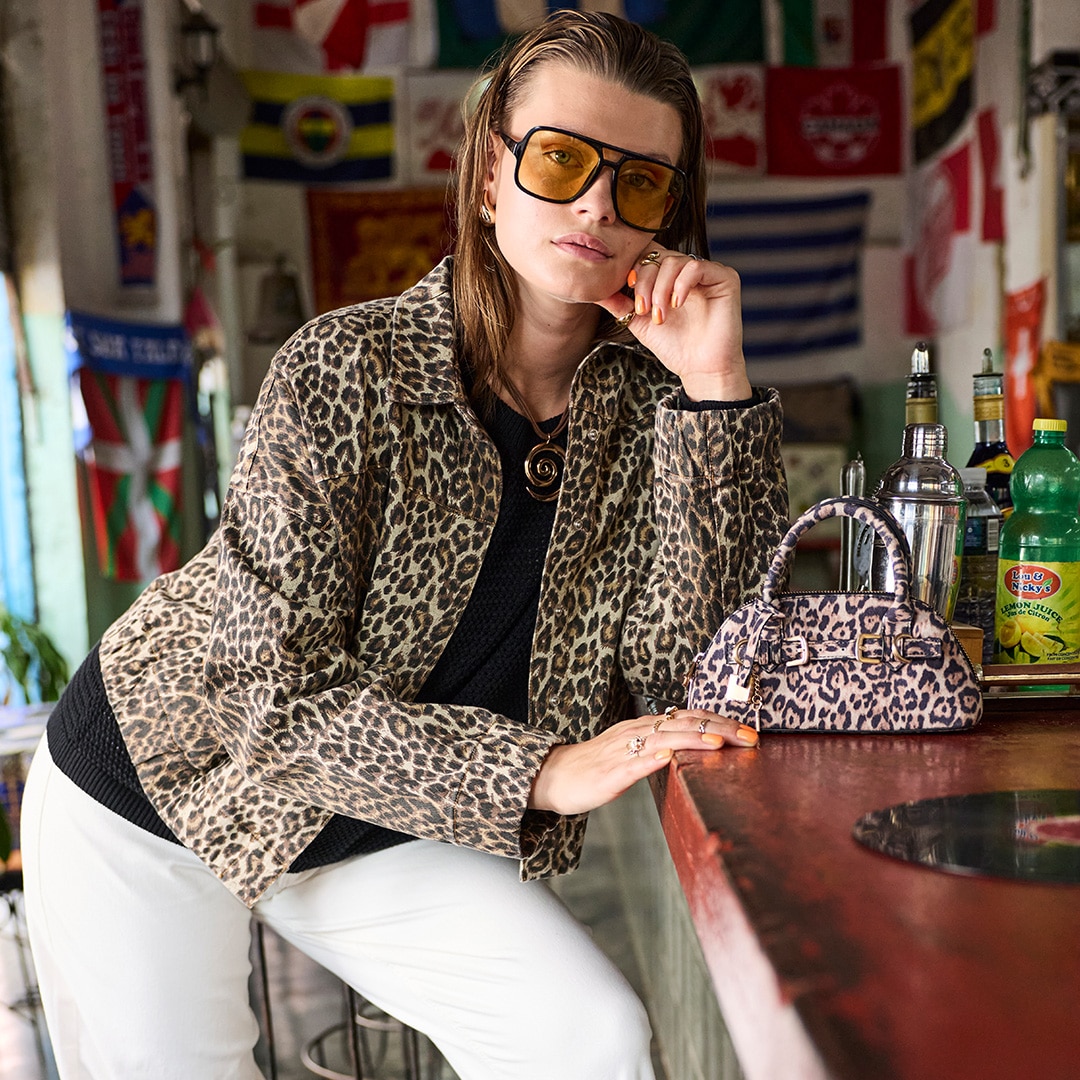 The model is wearing a jacket with leo print