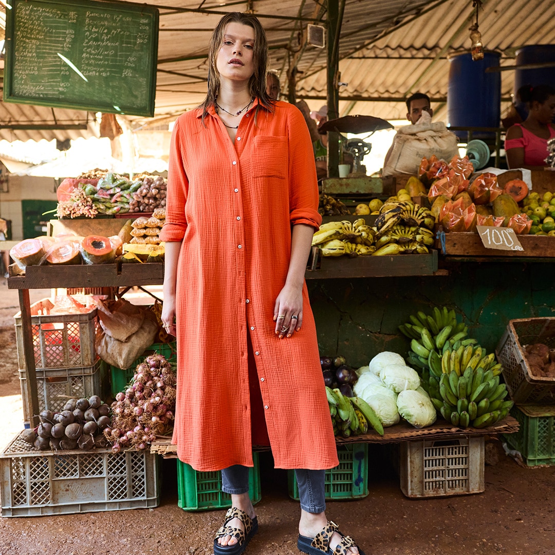 The model is wearing a red dress