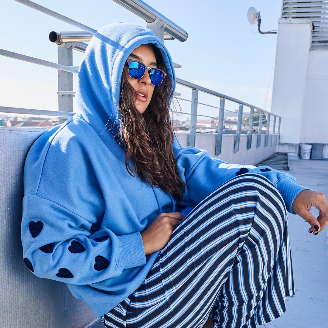 The model is wearing a jacket with leo print