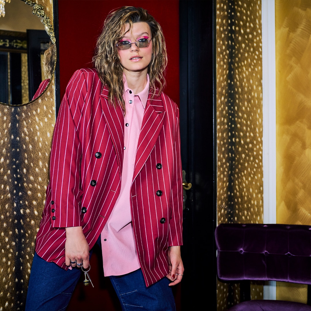 The model is wearing a suit in zebra print