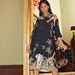 The model wears a patterned dress