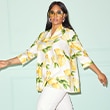 The model is wearing ad blouse with lemon print