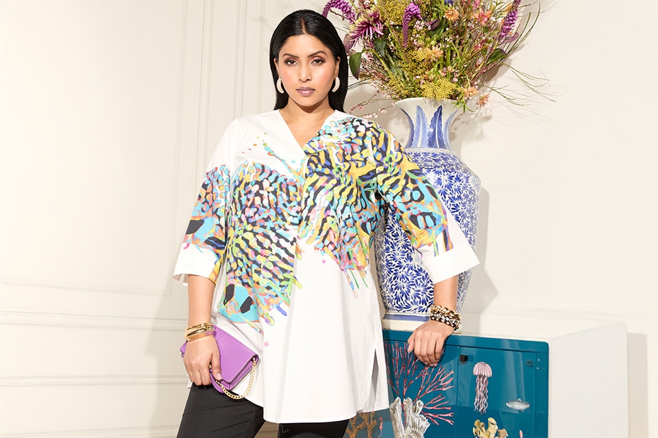 The model wears a colorful blouse