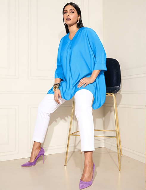 The model wears a blue blouse
