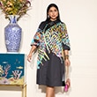 The model wears a dress with a colorful pattern
