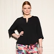 The model wears a black blouse