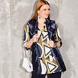 The model is wearing a blouse with a graphic pattern.