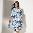 The model is wearing a colorful dress