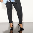 The model wears black trousers
