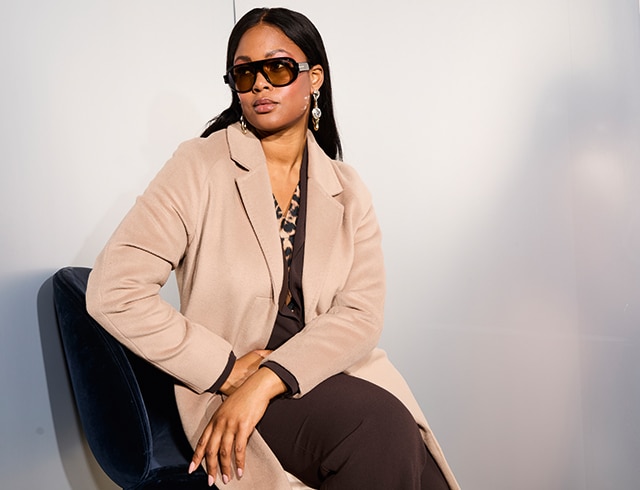 The model is wearing a beige coat.
