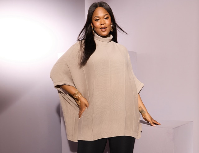 The model is wearing a poncho