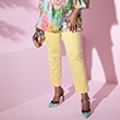 The model poses in a yellow and white striped dress