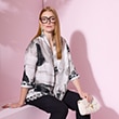 The model is wearing black-and-white satin blouse