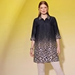 The model is wearing a black blouse with leopard print.
