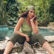The model wears a green top.
