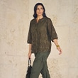 The model is wearing a green blouse.