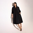 The model is wearing a black dress