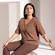 The model wears a brown shirt.
