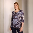 The model wears a shirt.
