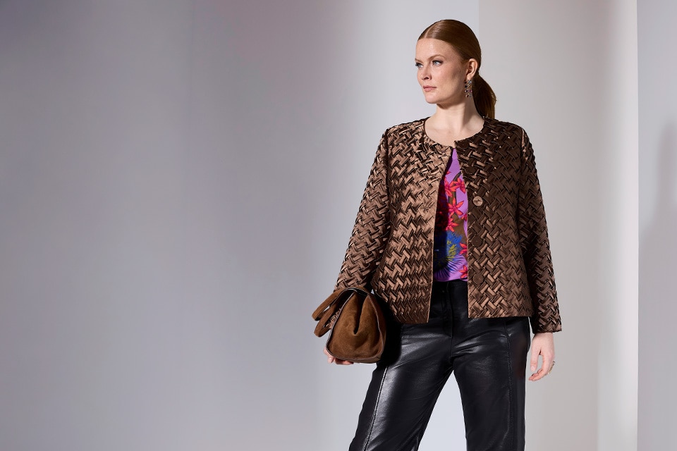 The model wears a brown jacket.