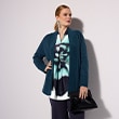 The model wears a cardigan.
