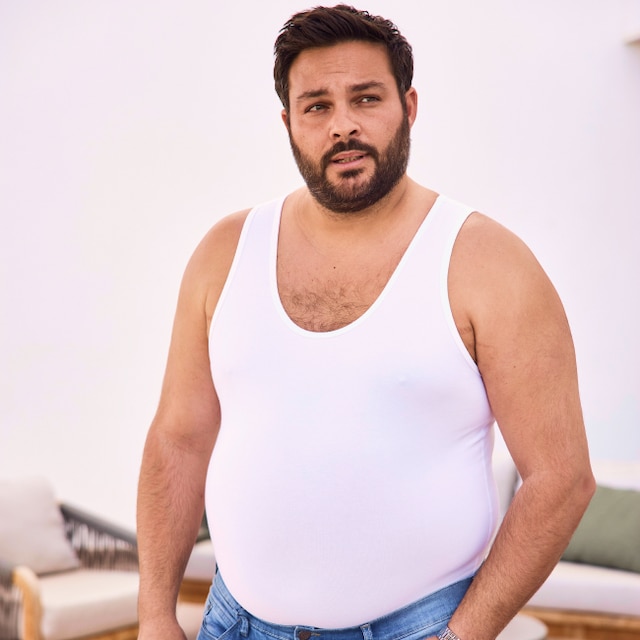 A Men is wearing a white tank top