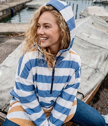 Model sits in a blue car wearing a flowered dress
