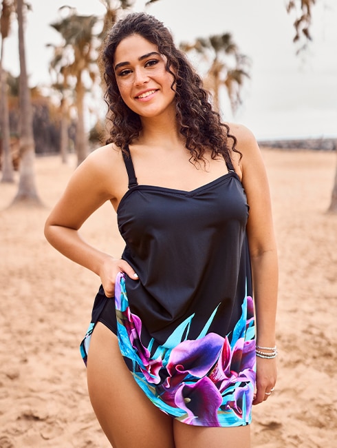 The model wears a figure-flattering swimming costume