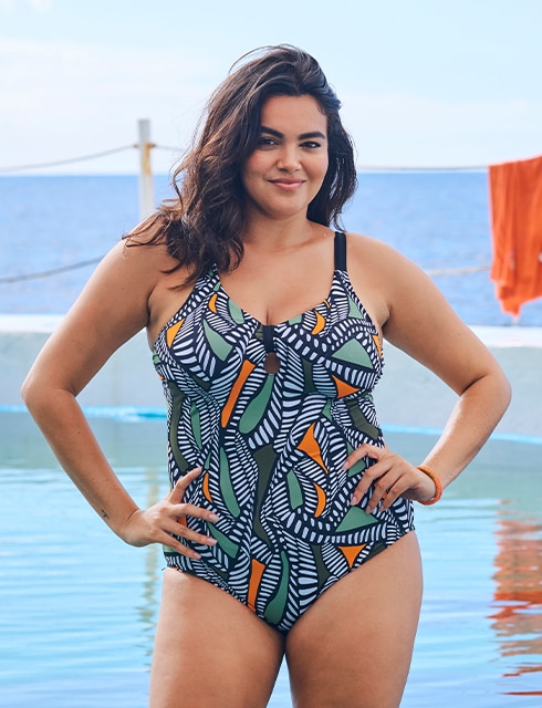 the model poses in a swimming costume