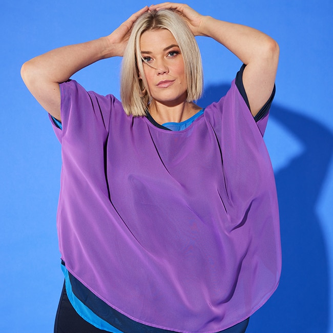 The model is wearing a purple sweatpants