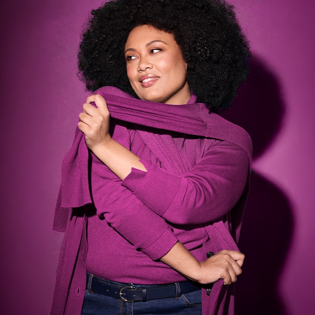 Model wearing a berry-colored cardigan