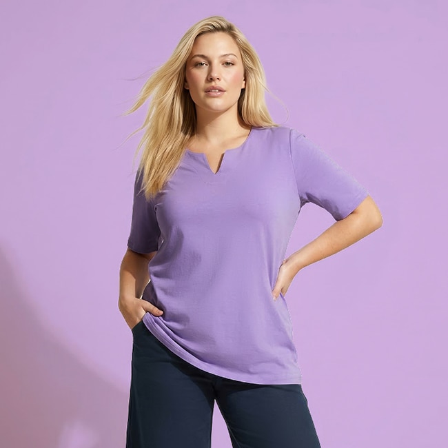 The model is wearing a purple sweatpants